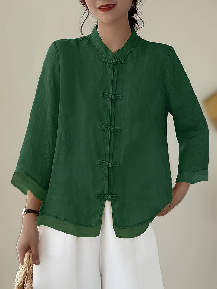 Women's elegant mandarin collar blouse with unique frog buttons, perfect for work or casual events.