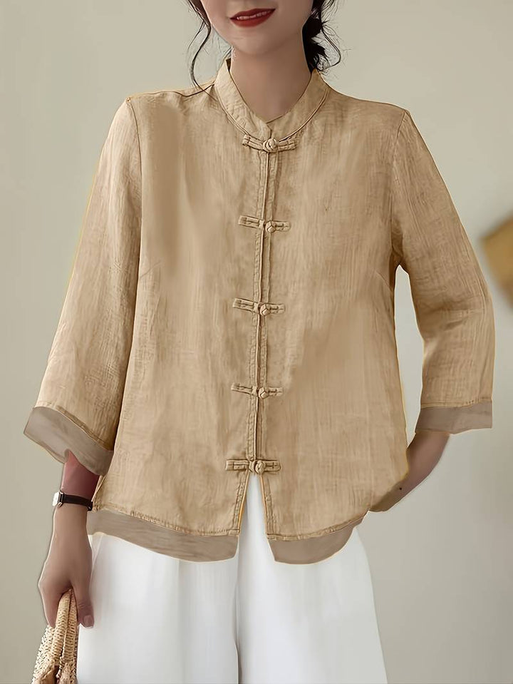 Women's versatile mandarin collar blouse with frog buttons, suitable for both casual & formal settings.