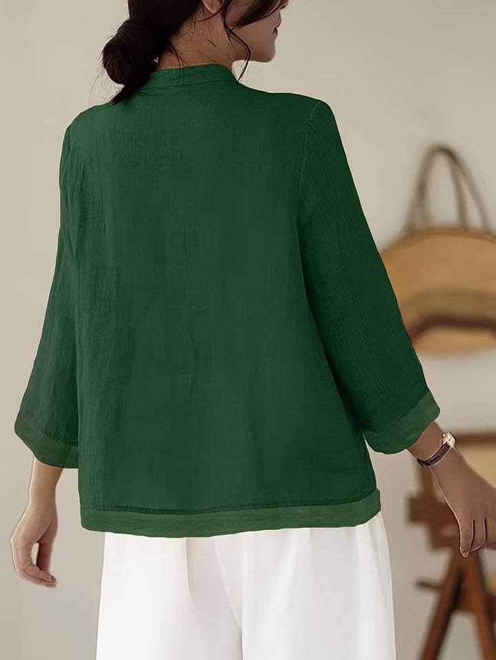 Women's tailored blouse for summer, featuring a mandarin collar and decorative frog button details.
