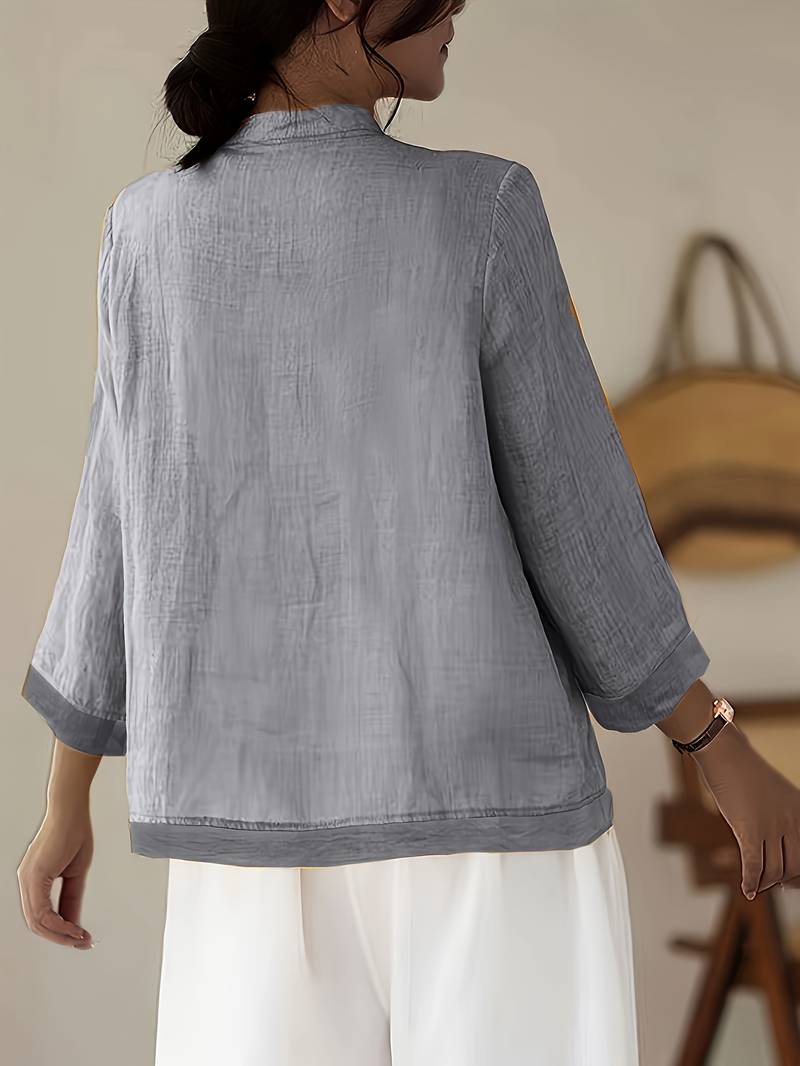 Elegant and casual women's blouse with a classic mandarin collar and stylish frog button closure.