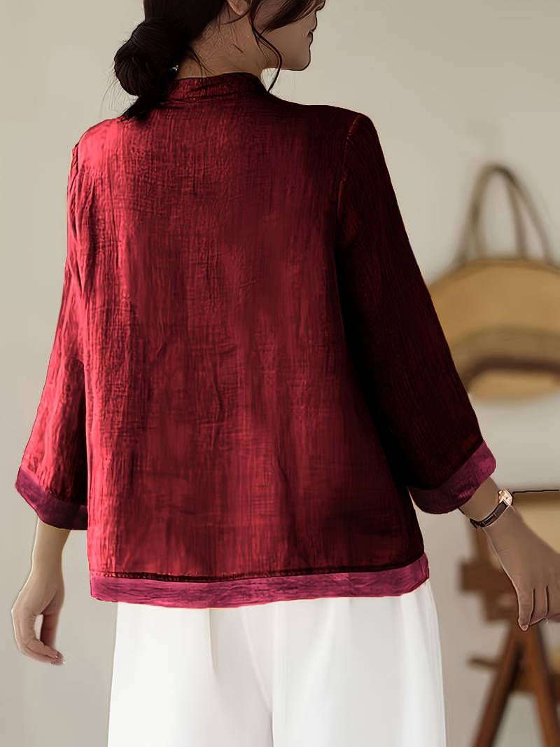 Women's three-quarter sleeve blouse, mandarin collar, frog buttons, perfect for smart-casual events.