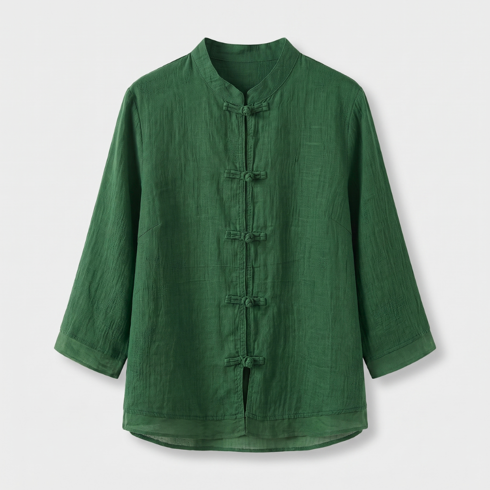 Tailored women's blouse featuring a mandarin collar & frog buttons, three-quarter sleeves. Versatile style.