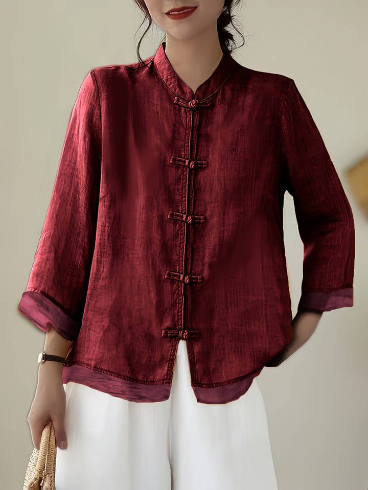 Elegant women's summer fashion blouse with mandarin collar and distinctive frog buttons. Tailored fit.