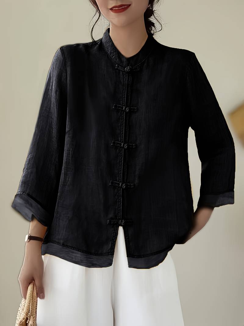 Stylish women's work wear blouse with a chic mandarin collar and decorative frog buttons. Comfortable.