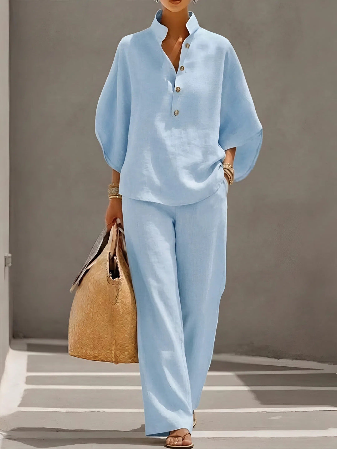 Coordinated women's mandarin collar top and wide-leg pants set, offering casual elegance for summer.