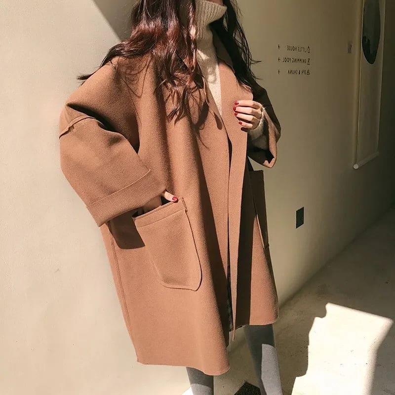 Elegant women's oversized trench coat, ideal for business casual or professional fall and winter outerwear.
