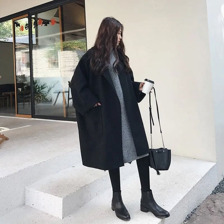 Stylish women's oversized trench coat with a classic collar and belt, offering a chic look for fall outerwear.