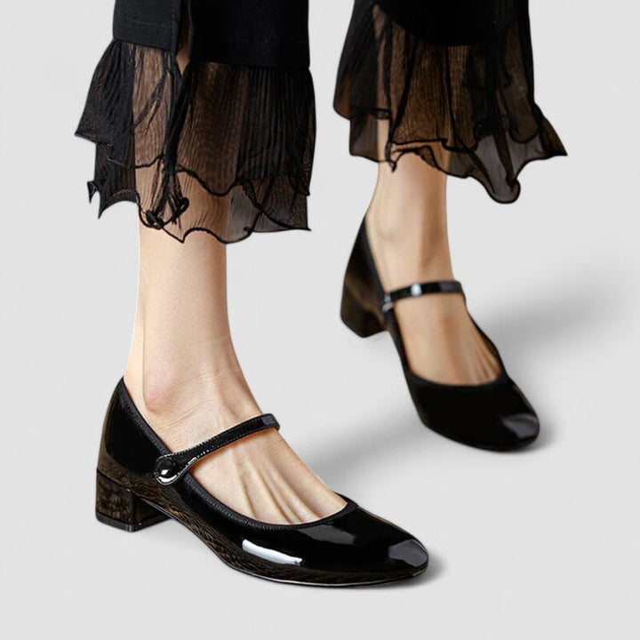 Women's elegant patent Mary Jane shoes with comfortable block heel & classic round toe. Perfect for work or dress.