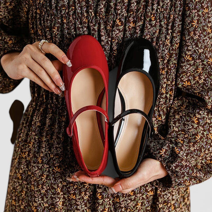 Close-up of elegant women's patent Mary Jane shoe, showcasing the glossy finish, block heel, strap, and round toe.