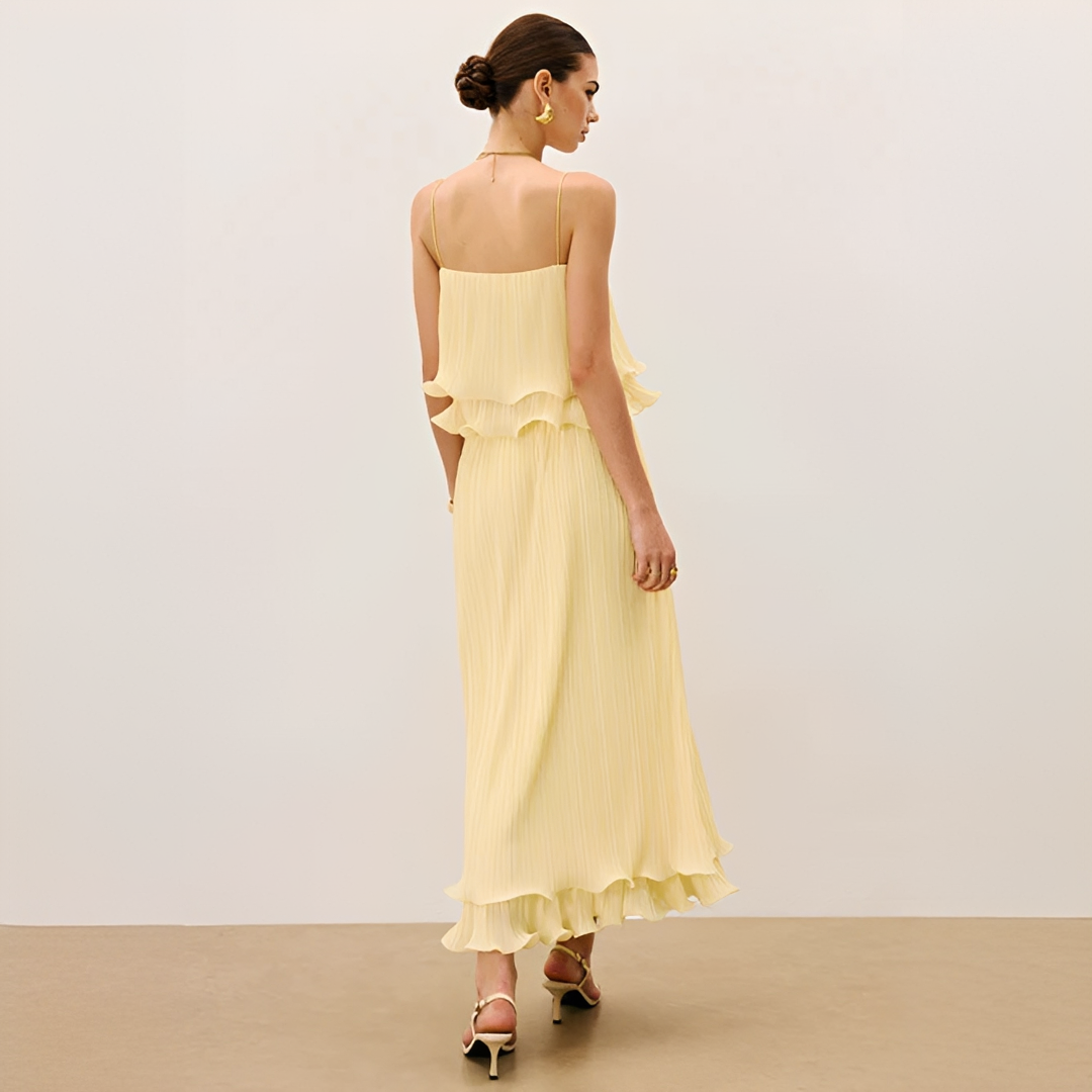 Fashionable women's pleated maxi co-ord set featuring pretty ruffles. Versatile elegant attire for any event.