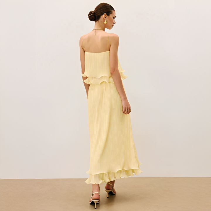 Fashionable women's pleated maxi co-ord set featuring pretty ruffles. Versatile elegant attire for any event.