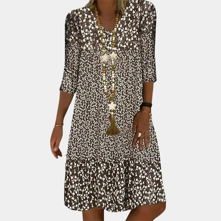 Comfortable & flowy women's printed midi dress, versatile for casual or elegant wear. Features a stylish V-neck design.