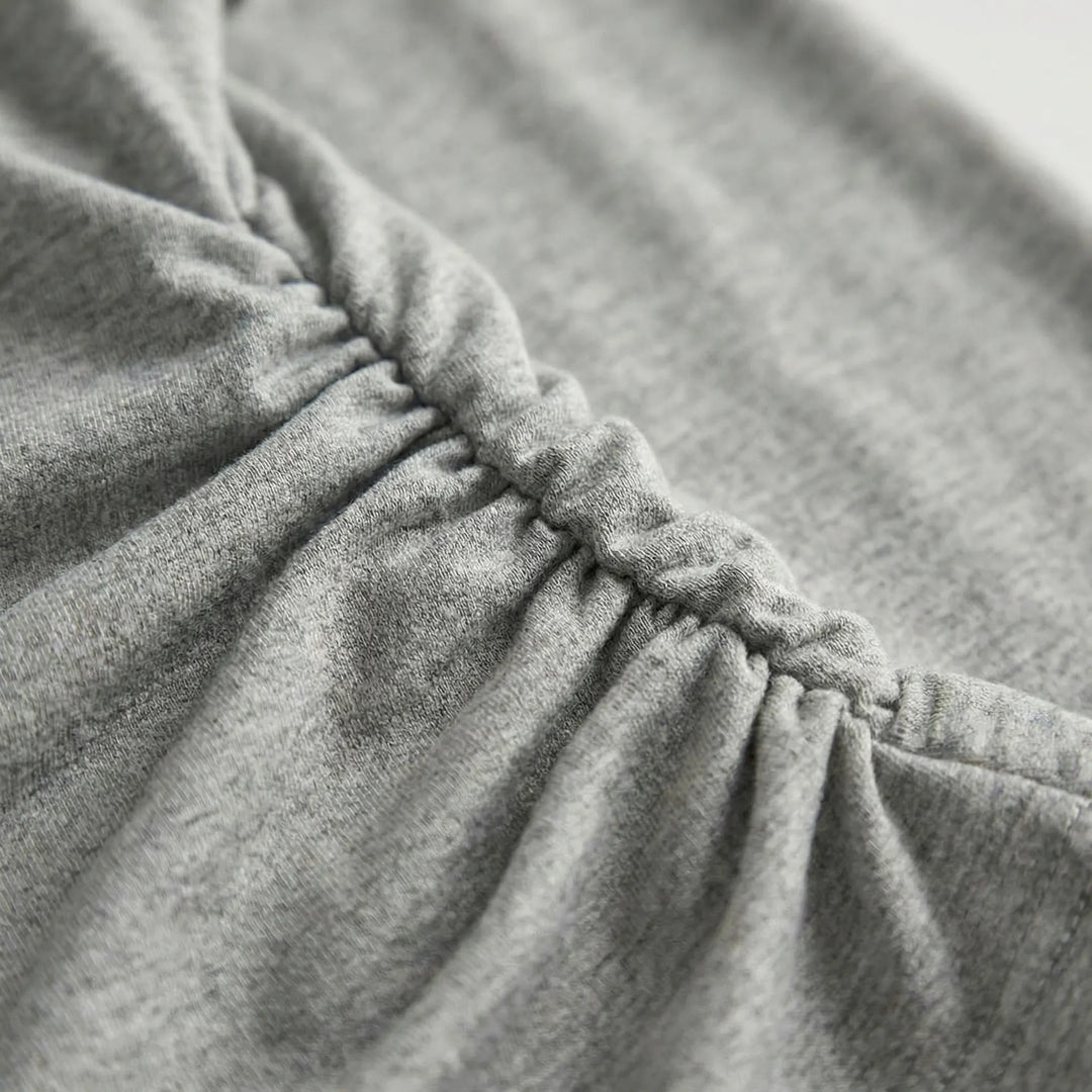 Modern women's ruched long sleeve top. A versatile layering piece for elegant or casual everyday fashion.