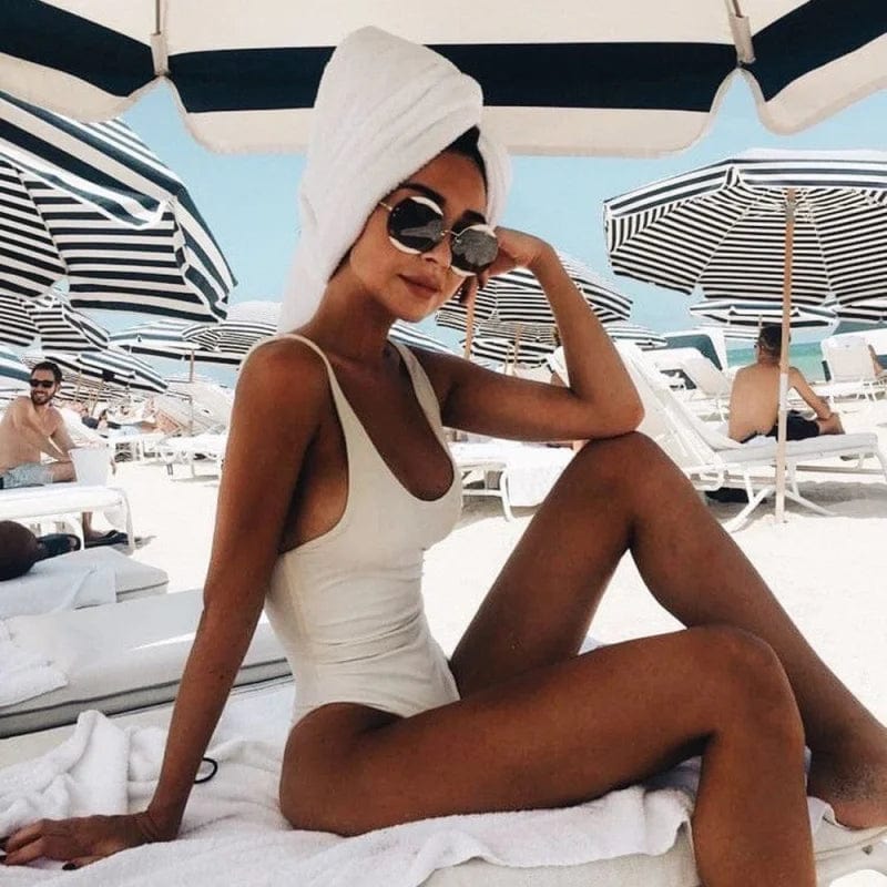 Chic women's one-piece bathing suit with flattering scoop neck and stylish open back design.