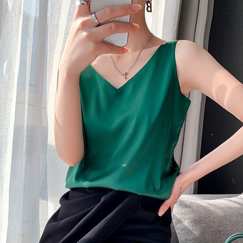 Chic women's sleeveless tank top with relaxed, draped fit. Silky look, perfect for elegant summer fashion.