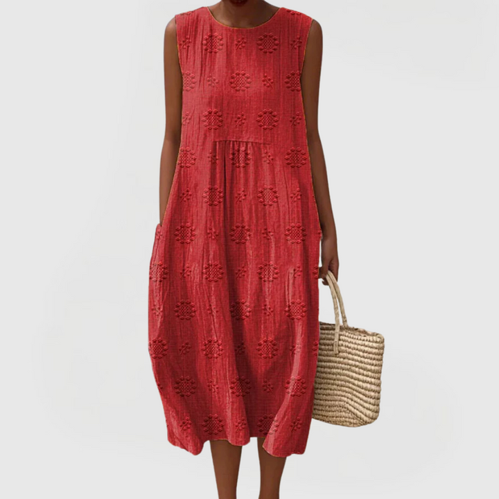 Stylish embroidered sleeveless women's dress with practical pockets, offering an elegant look for summer.