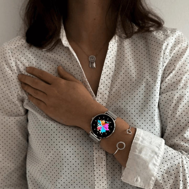 Slim silver fitness watch for women. Tracks workouts, calories, & activity. Smart wearable tech.
