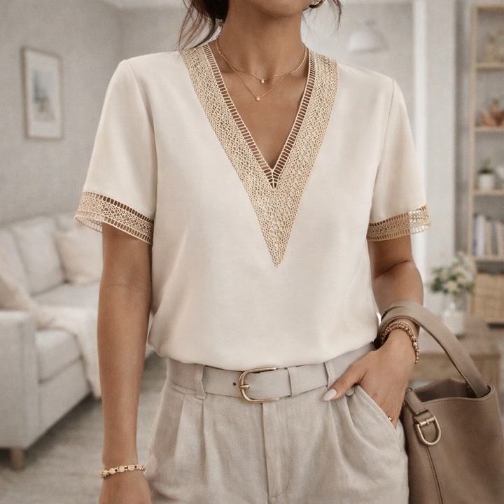 Women's elegant V-neck blouse with delicate lace trim, perfect for chic spring and summer fashion.