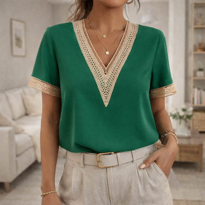 Feminine women's V-neck blouse with intricate lace trim and short sleeves for comfortable spring/summer fashion.