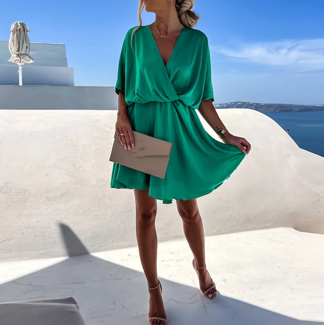 Chic women's V-neck skater mini dress, featuring a flowy wrap design for elegant summer style.