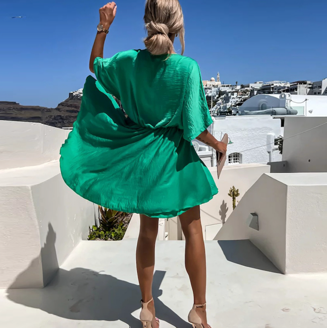 Elegant women's V-neck wrap mini dress. Flowy fabric & flattering silhouette for any summer occasion.