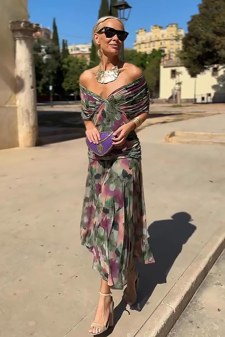 Woman in elegant V-neck maxi dress with flutter sleeves, perfect for evening events or formal wear.