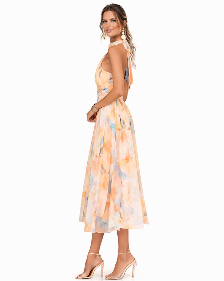 Elegant women's halter neck maxi dress featuring a beautiful watercolor print, ideal for summer occasion wear.