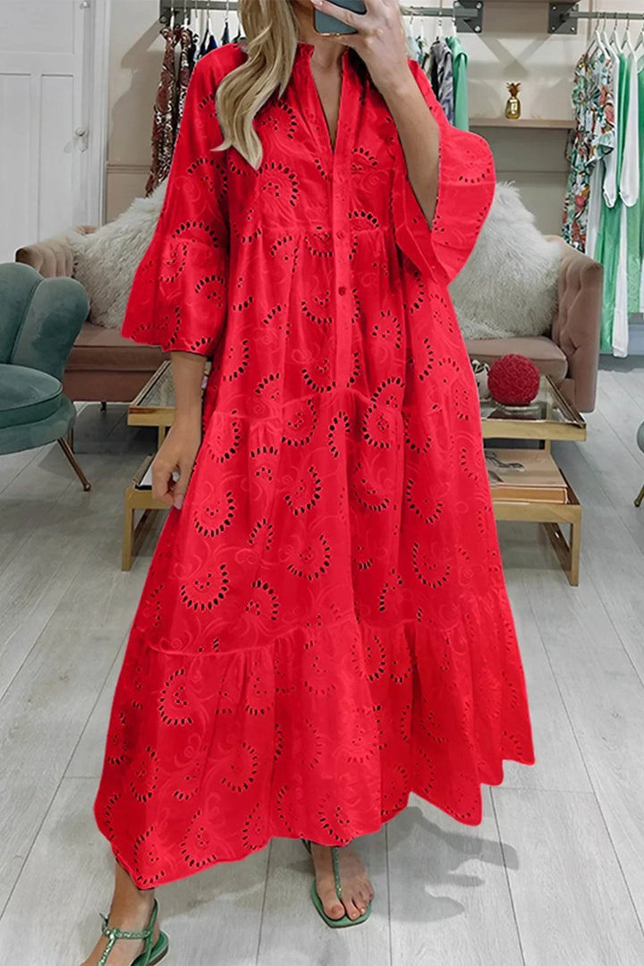 Elegant women's v-neck maxi dress with intricate embroidery, ideal for beach or resort wear.