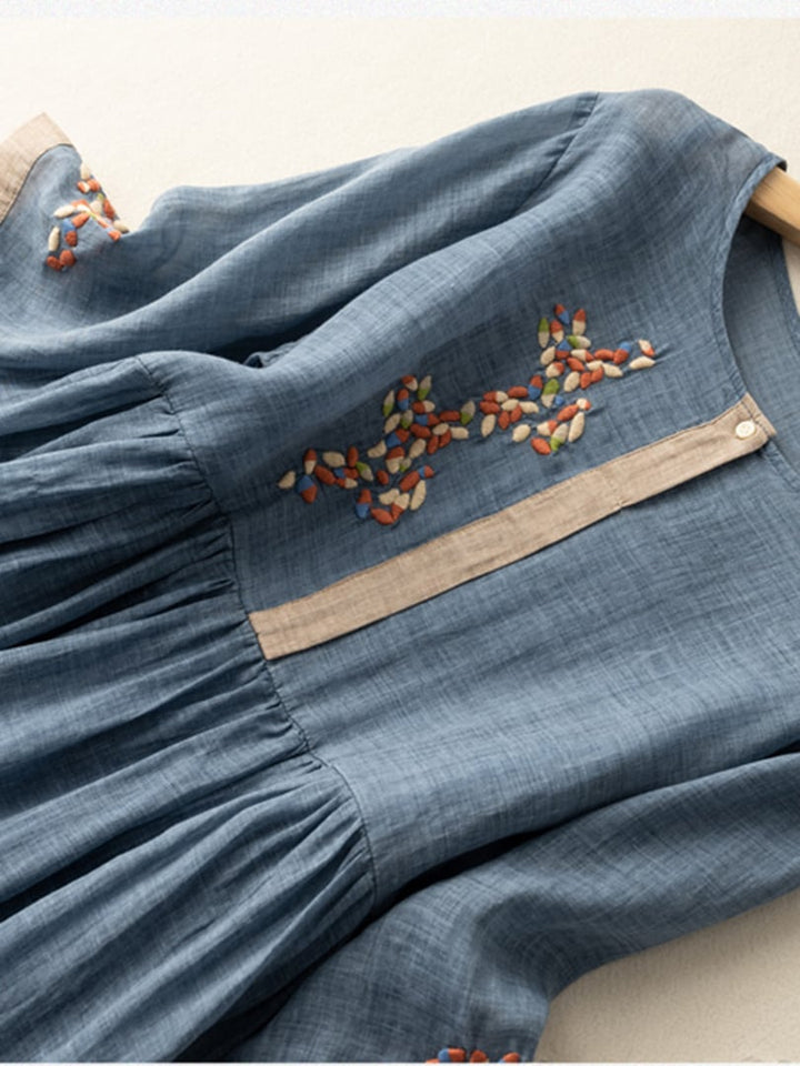 Women's relaxed fit boho midi dress, showing its loose silhouette & elegant embroidered design. Casual comfort.