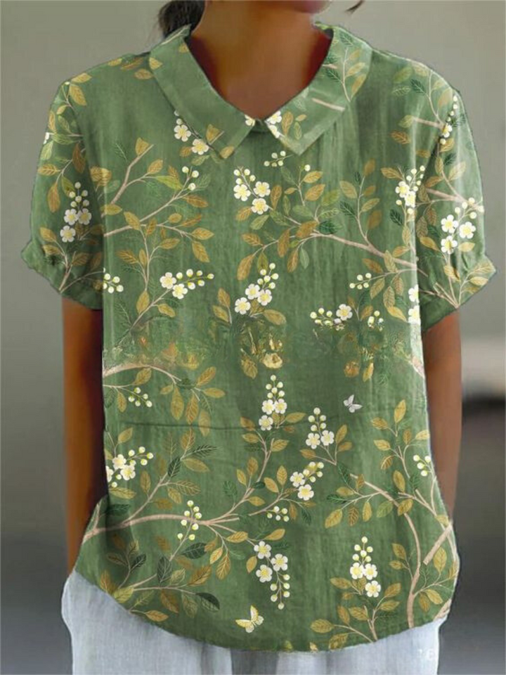 Versatile women's embroidered floral blouse with Peter Pan collar & relaxed fit, ideal for warm weather style.