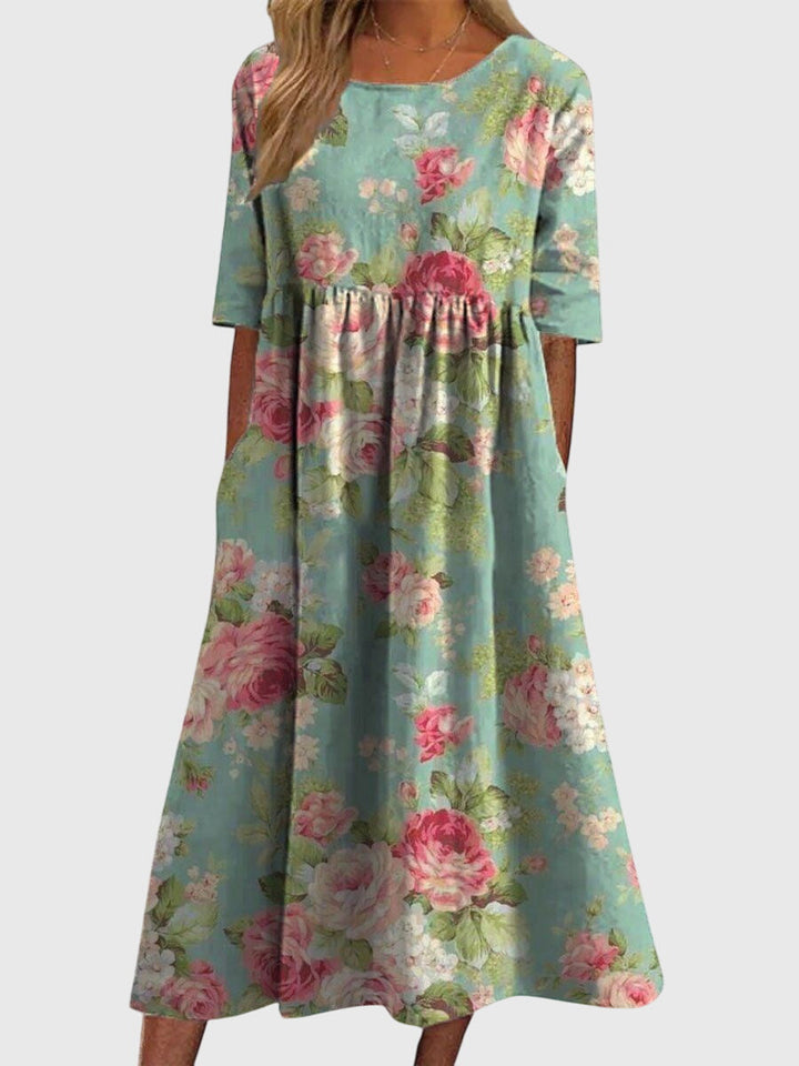 Close-up of elegant embroidery detail on a women's flowy midi dress, perfect for summer fashion and occasions.