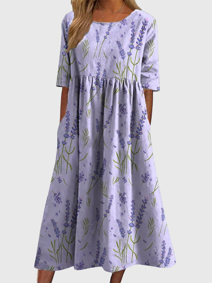 Woman in a stylish flowy midi dress, showcasing its comfortable relaxed fit, perfect for elegant summer fashion.