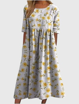 Chic women's embroidered midi dress styled for a relaxed, elegant look; a comfortable flowy summer fashion piece.