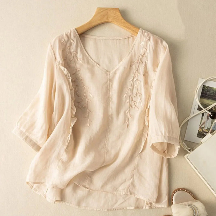 Summery women's linen blend blouse featuring beautiful embroidery and a relaxed fit