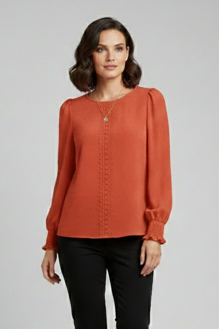 Model wearing a chic women's embroidered long sleeve blouse, round neck, for a refined look.