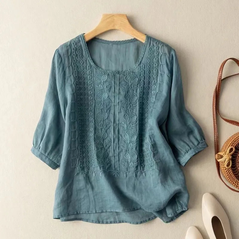 Loose fit women's embroidered puff sleeve blouse with a round neck & three-quarter sleeves. Casual elegant style.
