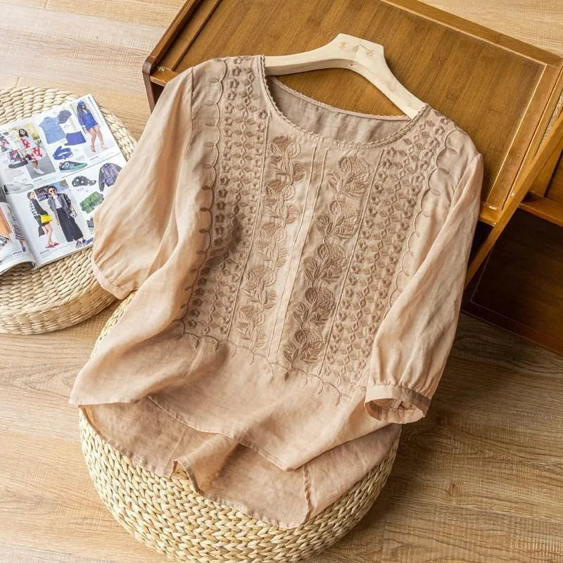 Full shot of a stylish women's embroidered puff sleeve blouse, featuring a flowy top, floral patterns & a comfortable design.