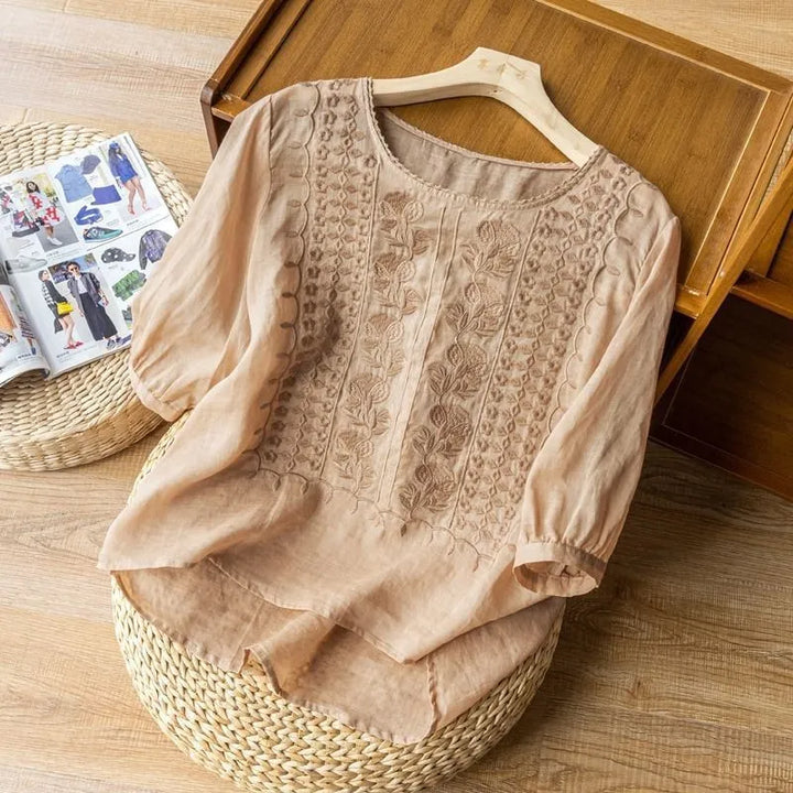 Full shot of a stylish women's embroidered puff sleeve blouse, featuring a flowy top, floral patterns & a comfortable design.