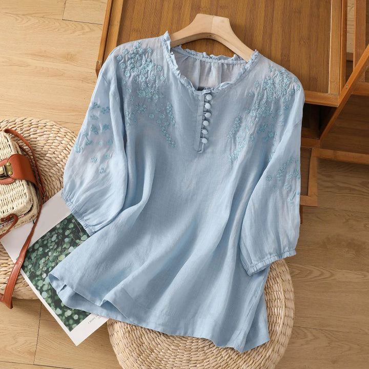 Women's embroidered short sleeve blouse with relaxed fit. Perfect for casual summer wear and everyday elegance.