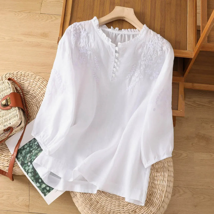 Relaxed fit women's short sleeve blouse featuring delicate embroidery. A comfortable & feminine top for daily wear.