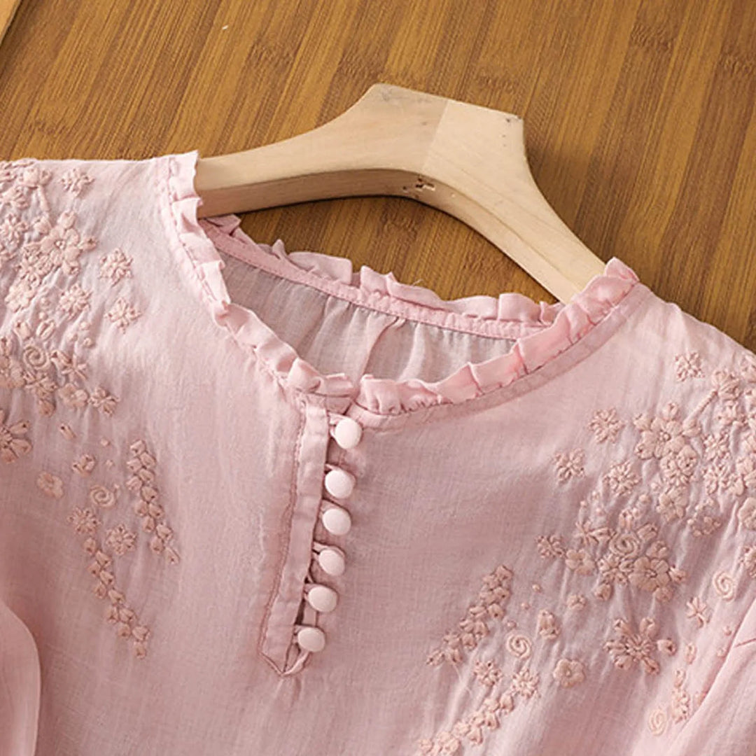 Feminine women's summer short sleeve blouse with beautiful embroidery. Flowy and relaxed fit for casual elegance.