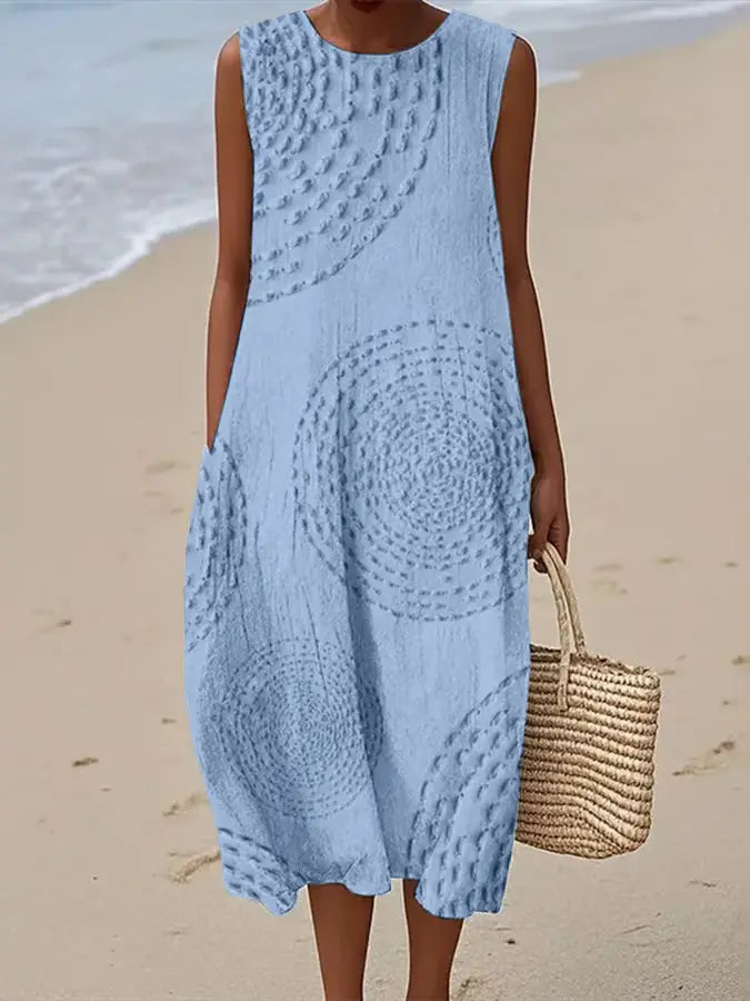 Elegant women's sleeveless embroidered midi dress. Floral pattern, round neck, A-line. Ideal for summer, resort, or day wear.