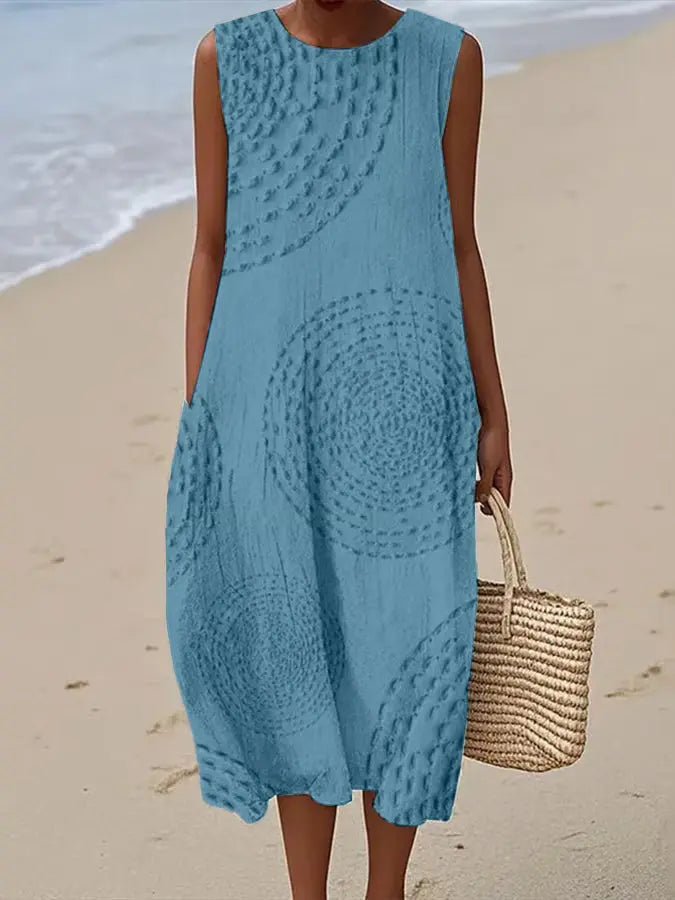 Beautifully embroidered sleeveless midi dress for women. Features delicate floral patterns, a round neck & flattering A-line silhouette.