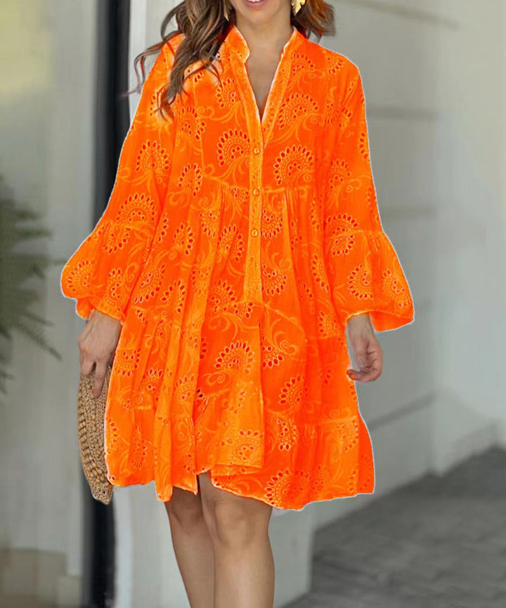 Chic women's tiered mini dress, intricate embroidery, V-neckline, and flared bell sleeves.