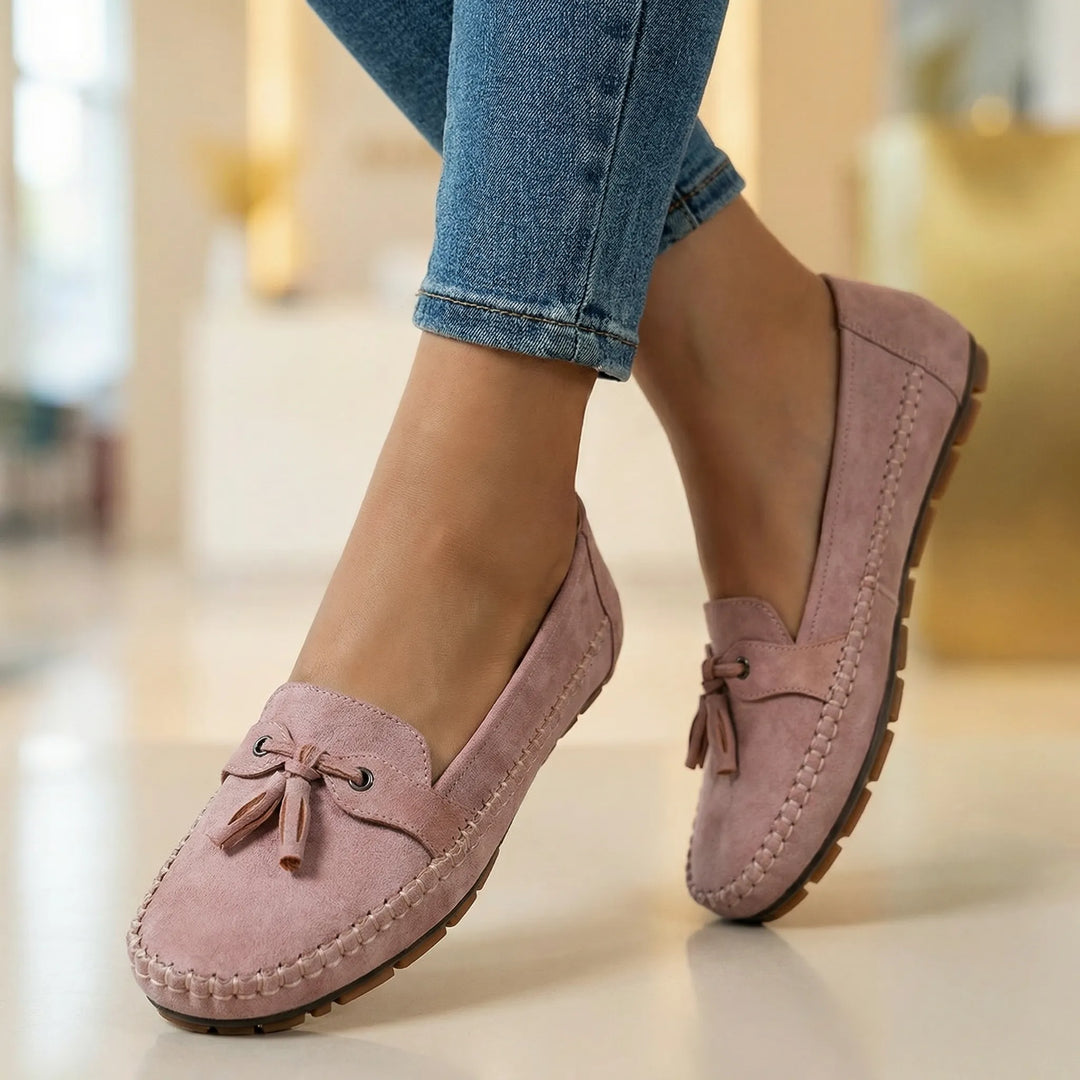 Woman walking in extra wide memory foam loafers, experiencing comfortable all-day support.