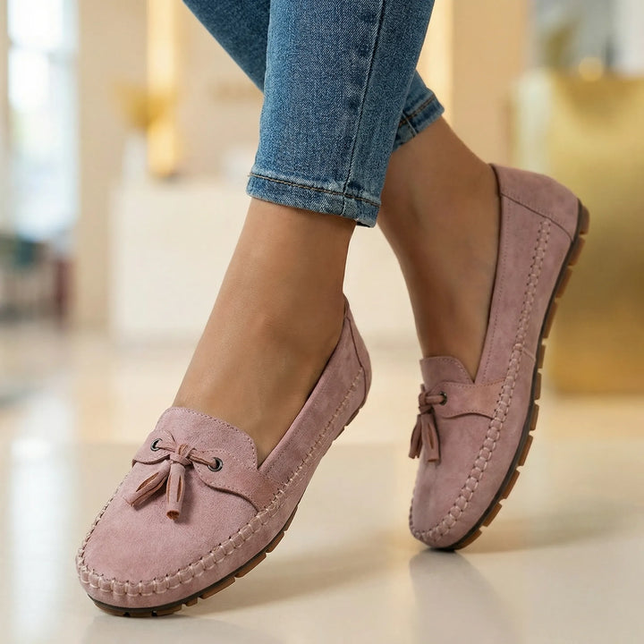 Woman walking in extra wide memory foam loafers, experiencing comfortable all-day support.