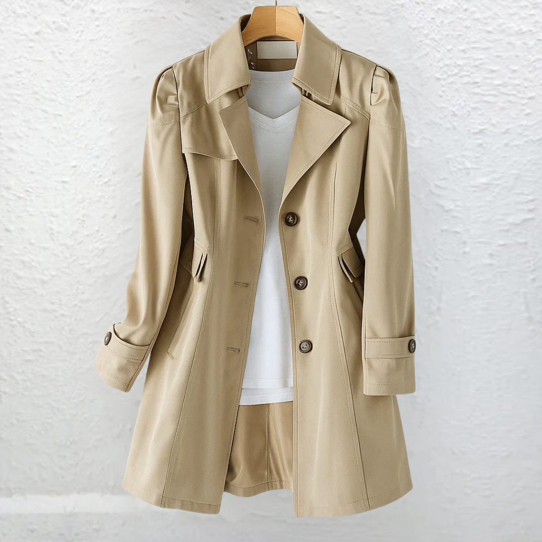 Vintage-style women's long trench coat featuring a fitted silhouette, structured collar, and elegant belt for fall.