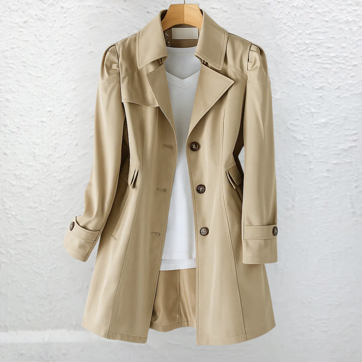 Vintage-style women's long trench coat featuring a fitted silhouette, structured collar, and elegant belt for fall.