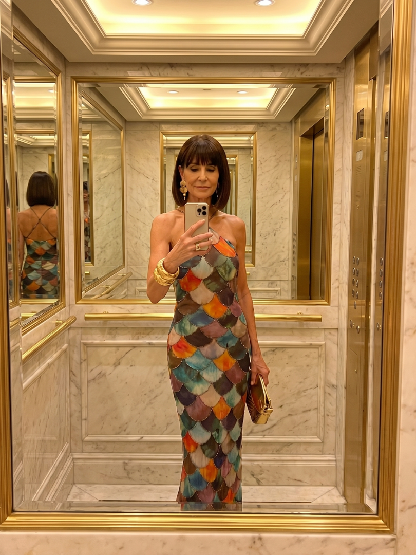 Sleeveless women's halter maxi dress with a unique geometric pattern. Fitted for a flattering look, ideal for summer fashion.