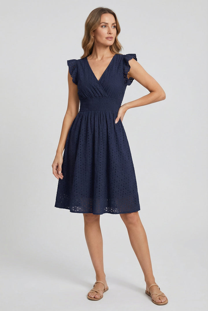 Day dress for women: white eyelet midi with a flared hem, smocked waist, and adorable ruffled sleeves.